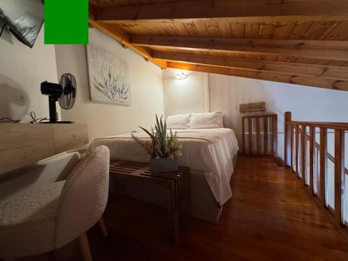 a bedroom with a bed and a table with a chair at Mersea standard apartment Kourouta in Kourouta