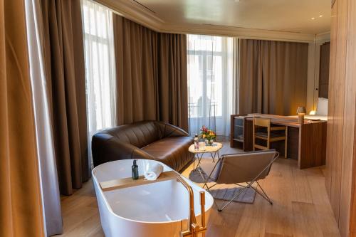 a living room with a couch and a table at Mercer Madrid in Madrid