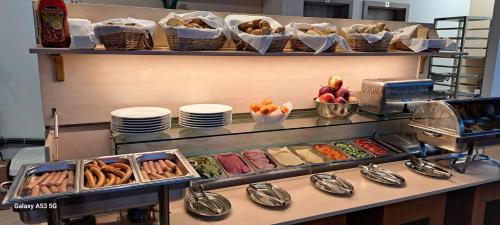 a buffet line with plates and bowls of food at Elite Pension in Štúrovo