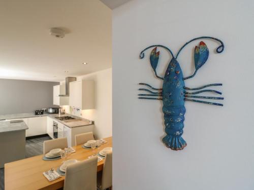 a blue lobster hanging on a wall in a kitchen at 38 The Parade in Walton-on-the-Naze