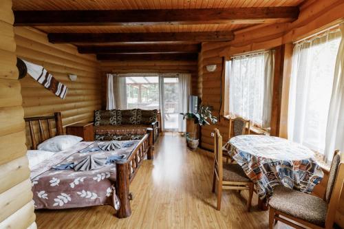 a room with two beds and a couch and a table at Gostynniy Dvir Raytshtoky in Vorokhta