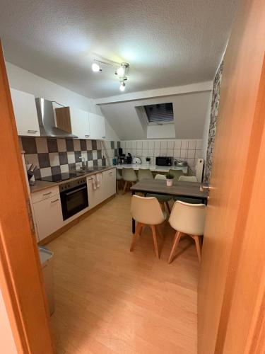 a kitchen with a table and chairs in a room at Apartment Zeitz Zangenberg groß in Zeitz