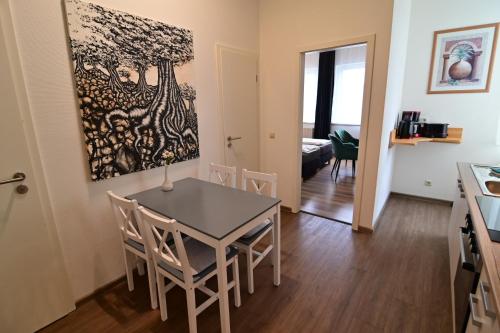 a kitchen and dining room with a table and chairs at Am Schloss 15 in Schwerin