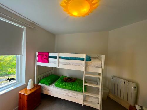 a bedroom with two bunk beds in a room at 4 Balvaig Cottage, Strathyre in Stirling