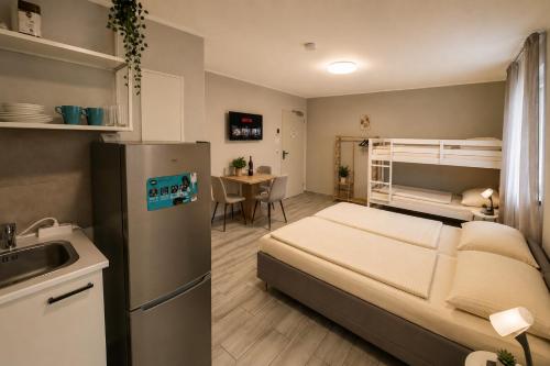 a small room with a bed and a kitchen at Prime Apartment Hotel in Nuremberg