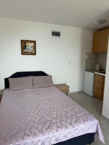 a bedroom with a bed with a purple bedspread at Villa Panoramic Sea View in Seoca