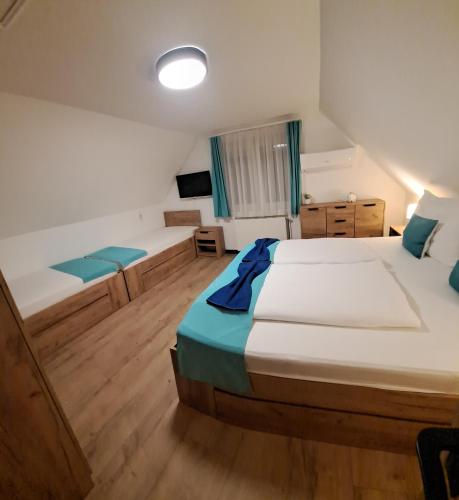 a large room with two beds and a television at Relax Apartman Bükfürdő in Bükfürdő