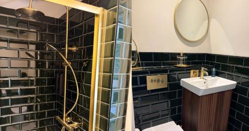 a bathroom with a sink and a mirror at The Carpenters Tavern in Dundry