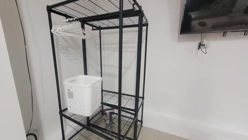 a black iron rack with a washing machine in it at beMyGuest Bangsaen in Ban Thai Don (1)