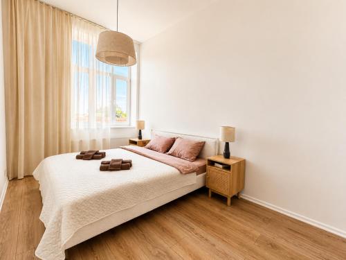 a bedroom with a large bed and a window at Sun Shine 1 apartment in Liepāja