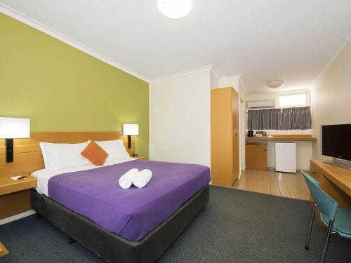 a hotel room with a bed with two white towels on it at ibis Styles Geraldton in Geraldton