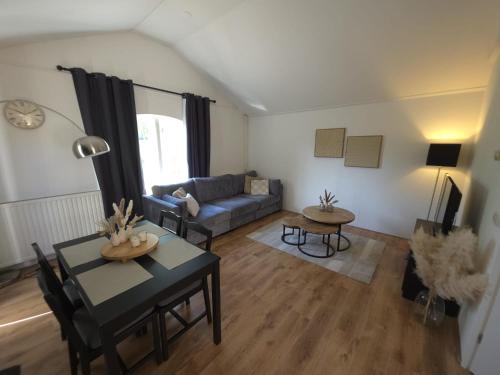 a living room with a couch and a table at Huisje 11 in Enschede