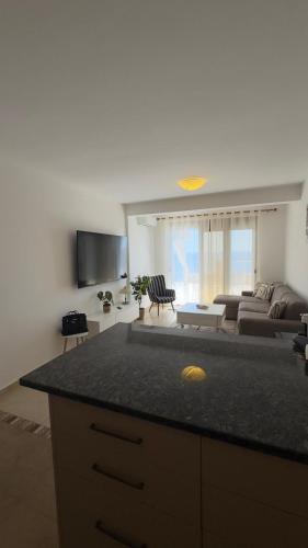 a kitchen and living room with a couch and a table at Luka private beach in Dobra Voda