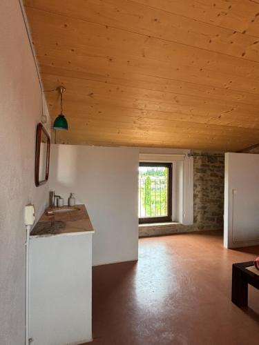 a kitchen with a sink and a wooden ceiling at Ca La Botera in Verges