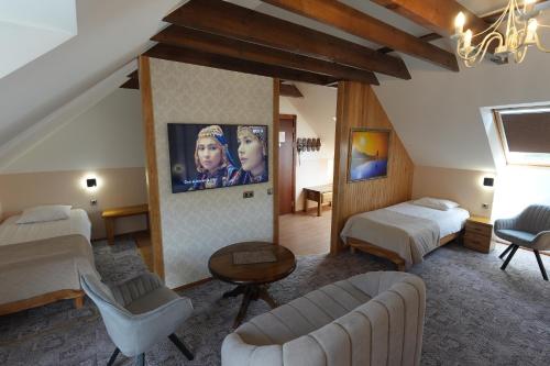 a large room with two beds and a couch at Ränduri Guesthouse in Võru