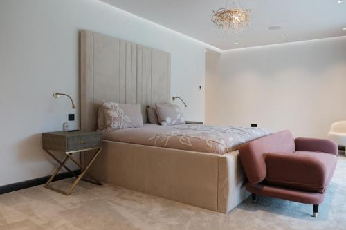 a bedroom with a bed and a chair at The Walled Garden House Rooms Only Not Entire House in Mundford