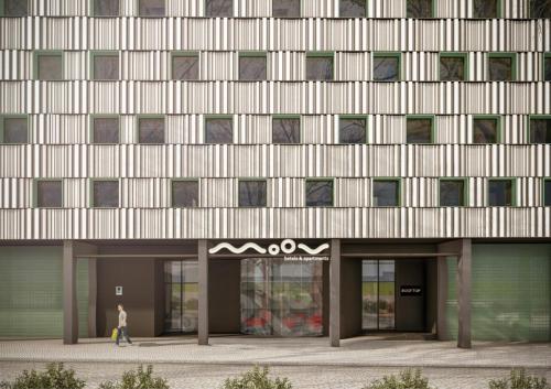 a person walking in front of a building at Moov Hotel Matosinhos Sul in Matosinhos
