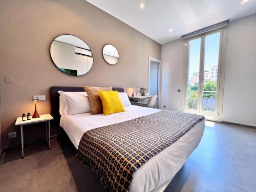 a bedroom with a large bed and two mirrors at My Residence d'Azur in Beausoleil