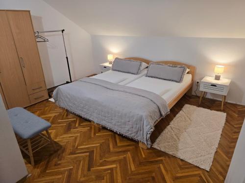 a bedroom with a bed with two pillows on it at Apartmani Zinda in Sukošan