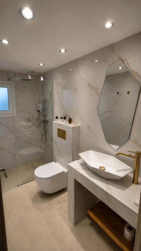 a bathroom with a toilet and a sink and a shower at Limera View Monemvasia in Monemvasia