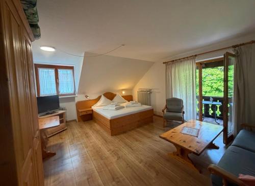 a room with a bed and a couch and a table at Ferienhaus Spornitz in Mittenwald