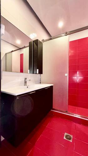 a bathroom with a sink and a red shower at elva creta beach in Palaiokastro