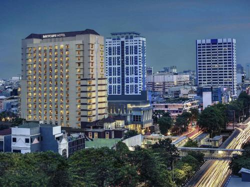 a view of a city with tall buildings at Mercure Jakarta Kota in Jakarta