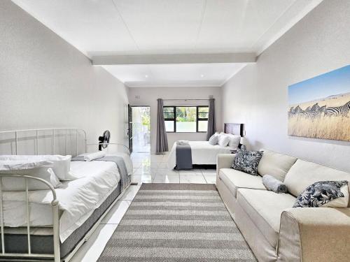 a living room with a couch and a bed at Manzini Chalet no20 in St Lucia
