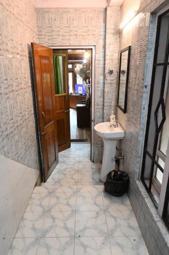 a bathroom with a sink and a toilet at Quinton Enclave in Shillong