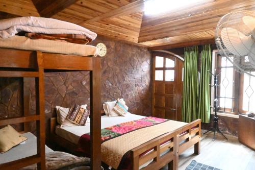 a bedroom with a bunk bed in a cabin at Quinton Enclave in Shillong