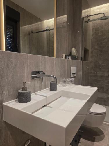 a bathroom with a white sink and a toilet at Villa Tedi in Podaca