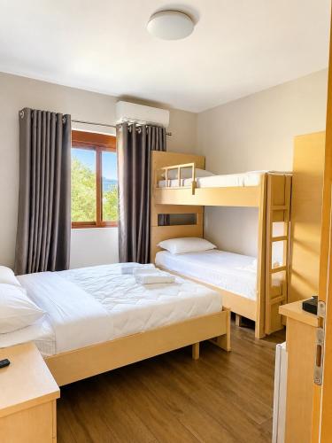 a bedroom with two bunk beds and a window at Artist House in Pogradec