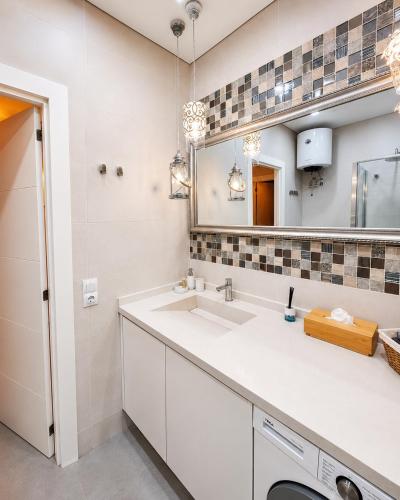a bathroom with a sink and a mirror at ORLANDO LUXURY APARTAMENT in Adeje