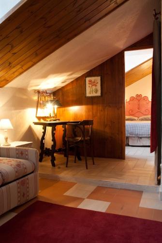 a living room with a table and a bed at Hotel PIAN DEL SOLE Claviere in Claviere