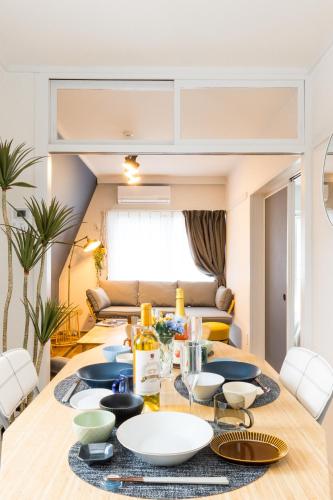 a dining room with a table with plates on it at Sunlife in Sendai