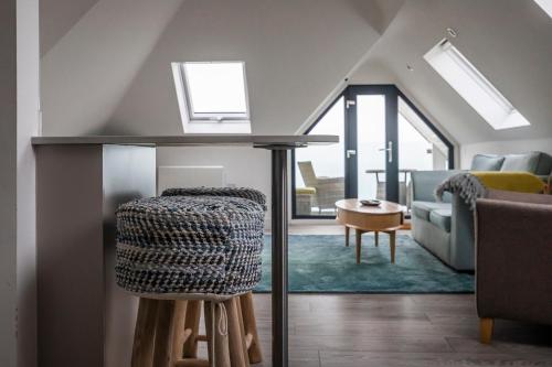 a living room with a table and a chair at Seaview apartment in Southbourne