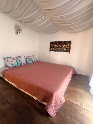 a bed with a red bedspread in a room at Grandma Stella's Old House in Apolakkiá