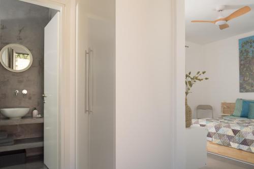 a bedroom with a bed and a ceiling fan at Galini Breeze in Agia Galini