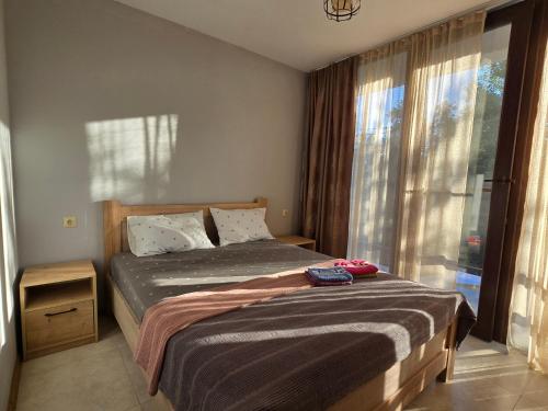 a bedroom with a bed and a large window at Dava&Davi in Ureki