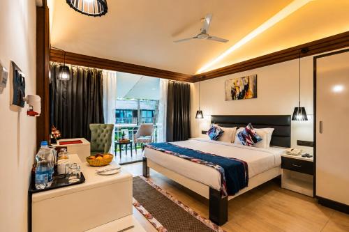 a hotel room with a bed and a balcony at Foxoso La Beach Resort & Spa in Old Goa