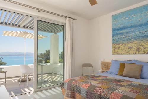 a bedroom with a bed and a view of the ocean at Galini Breeze in Agia Galini