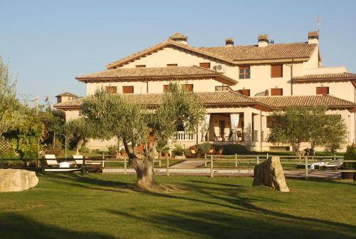 a large building with a tree in front of it at Hostería de Guara in Bierge
