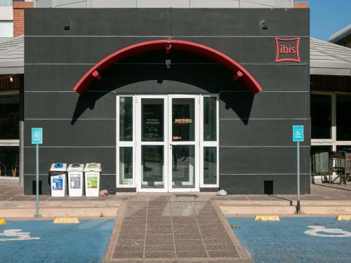 a black building with an arched doorway and a door at ibis Mendoza in Mendoza