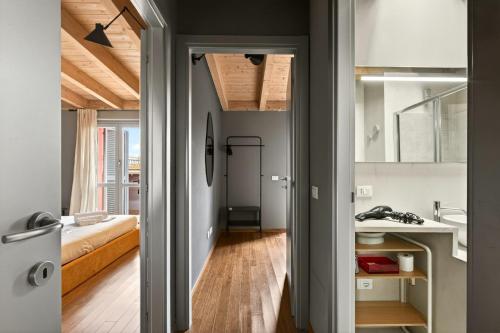 a bathroom with a sink and a bed in a room at Lulli mansarda- 7Sundays in Milan