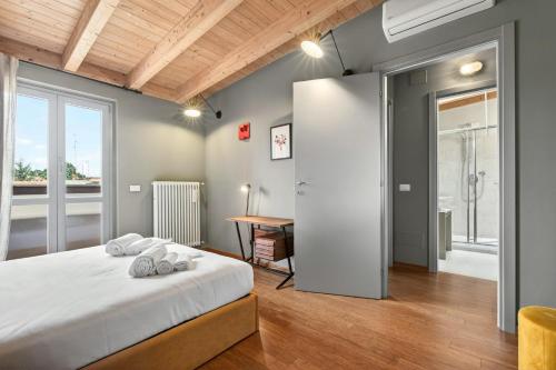 a bedroom with a bed and a desk in a room at Lulli mansarda- 7Sundays in Milan