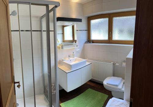 a white bathroom with a sink and a toilet at Appartement Anja in Fügen