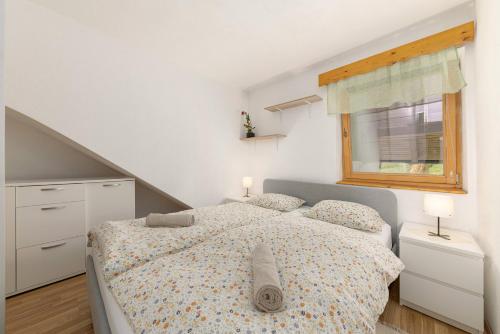 a bedroom with two beds and a window at 3 Rivers Apartment in Radovljica