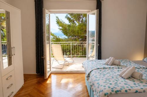 a bedroom with a bed and a door with a balcony at Apartment Nana in Primošten