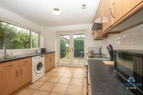 a kitchen with a washer and dryer at Millfield House by Blue Skies Stays in Middlesbrough