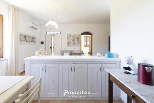 a kitchen with a sink and a counter top at Villa Rurale con Vista by Propertize in Monti